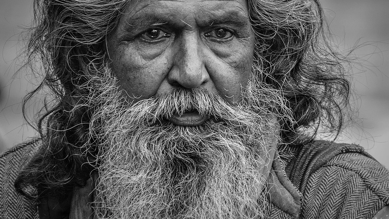 Rosto de homem com barba longa em retrato preto e branco, imagem ilustrativa