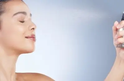 Imagem de pessoa aplicando bruma facial no rosto