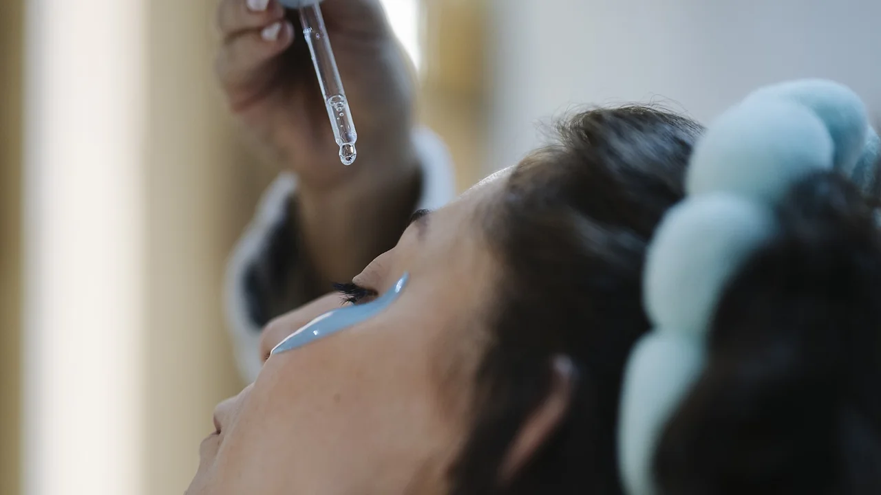 Aplicação ilustrativa de sérum facial com conta-gotas