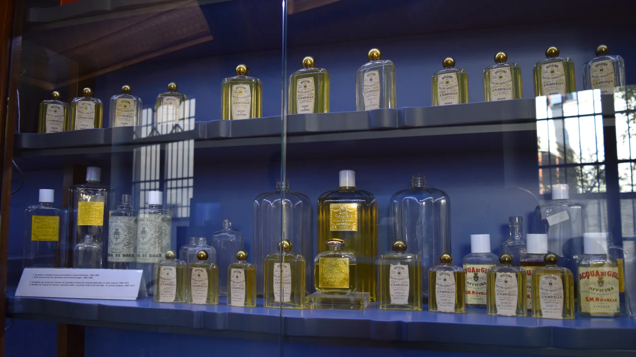 Frascos de perfume em vitrine, com rótulos visíveis para ilustrar a conferência de informações em embalagens cosméticas.