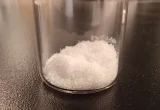 Cristais de ácido glicólico em um frasco de laboratório