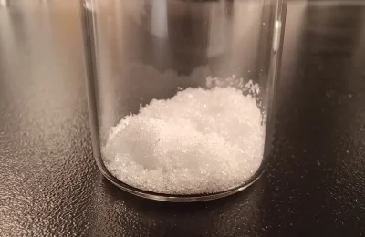 Cristais de ácido glicólico em um frasco de laboratório