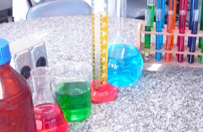 Vidrarias coloridas em um laboratório usadas para representar pesquisa e formulação de cosméticos